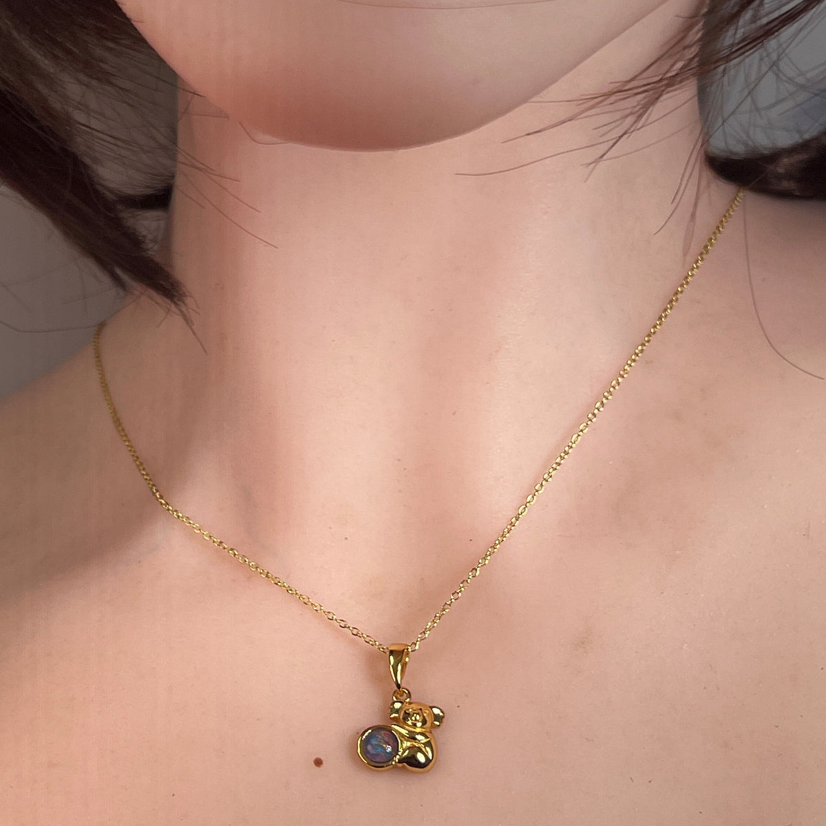 round Australian opal triplet pendant in yellow gold-plated silver, worn at the neck